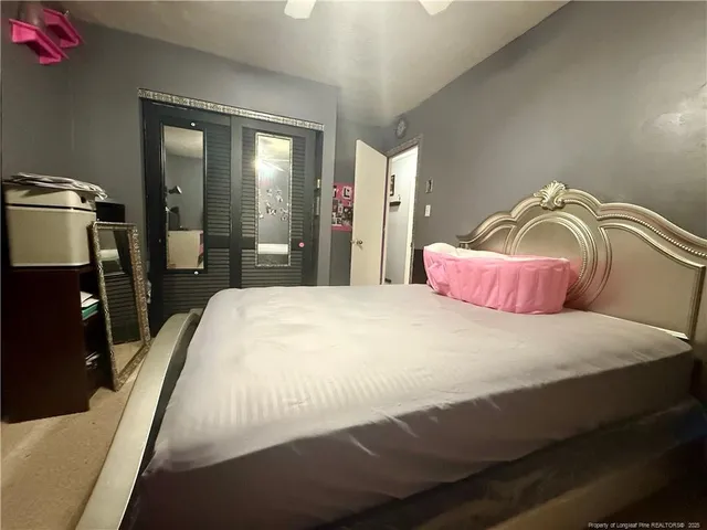 a bedroom with a bed and mirror