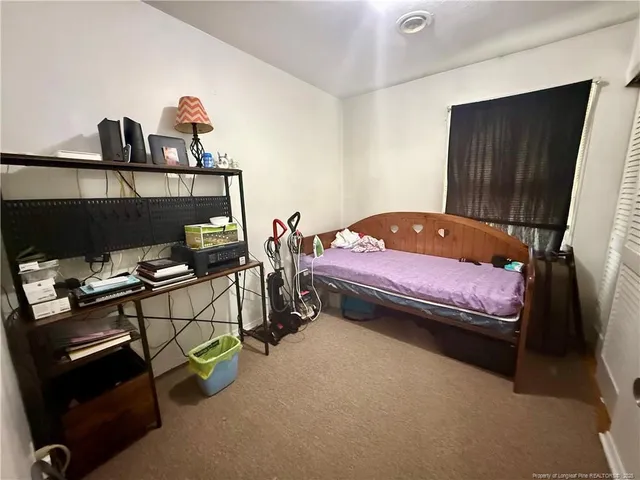 a bedroom with a bed and a tv