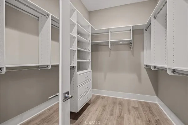 a view of walk in closet with empty racks