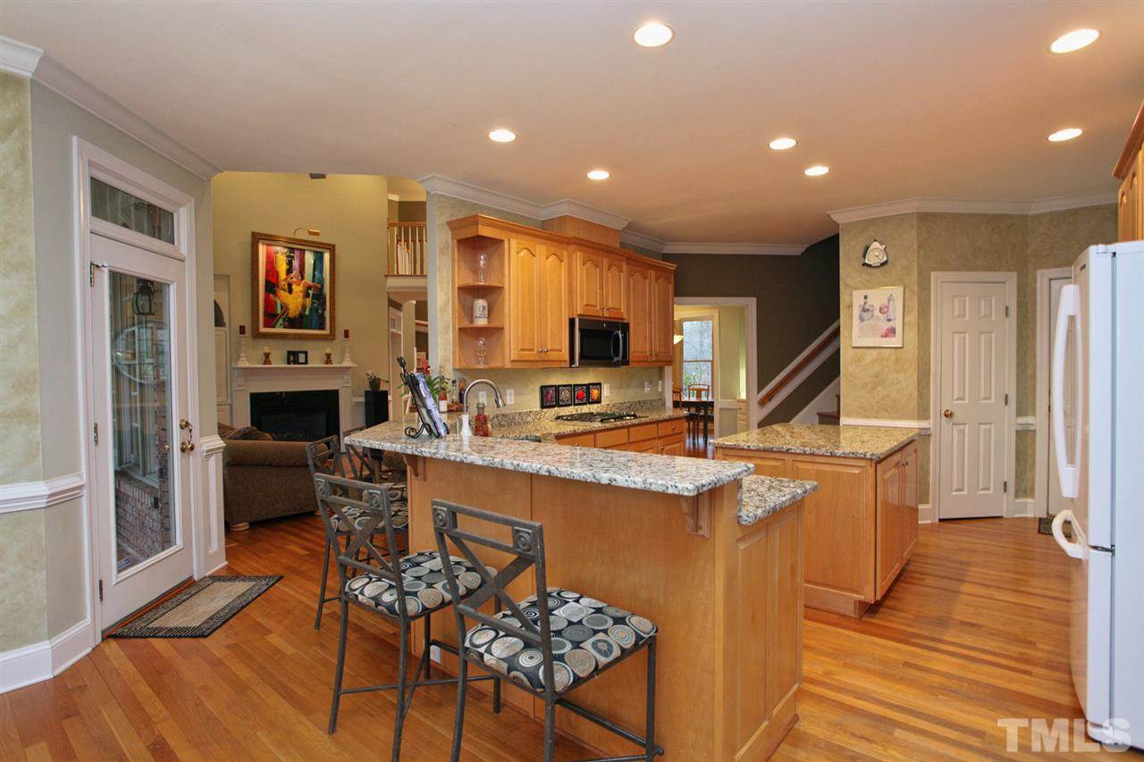 1405 Silverling Way Raleigh, NC 27613 - Photo 11 of 25 a large kitchen with stainless steel appliances granite countertop a stove and a refrigerator