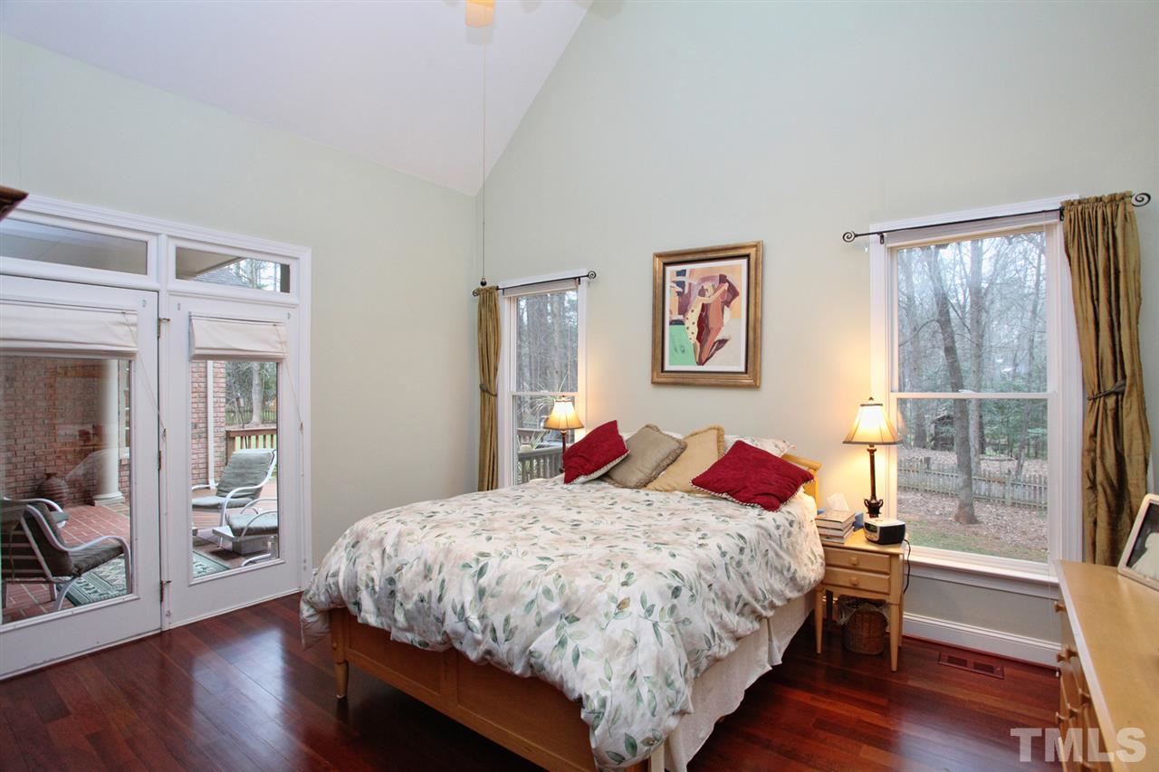 1405 Silverling Way Raleigh, NC 27613 - Photo 16 of 25 a bedroom with a bed and wooden floor