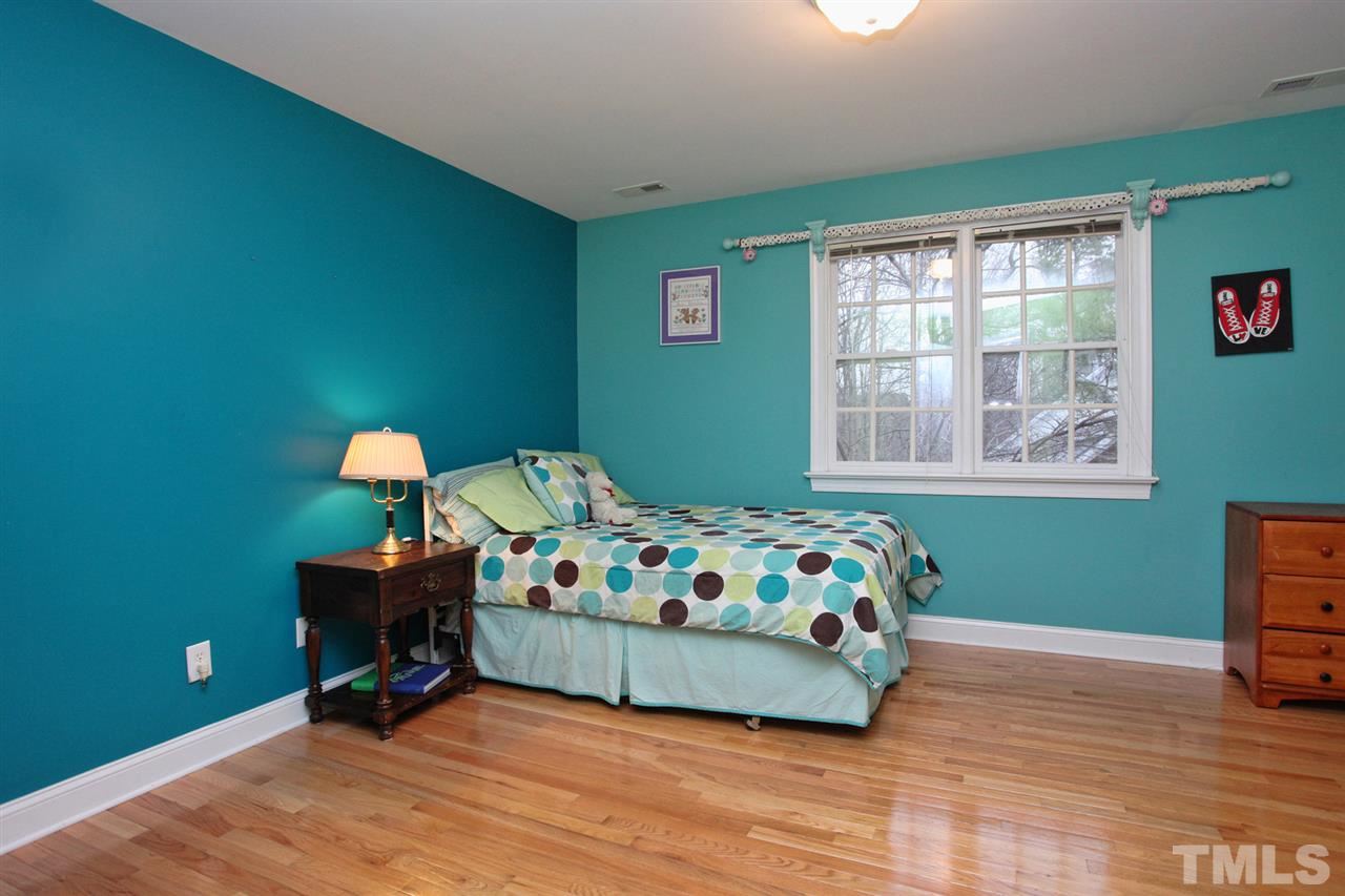 1405 Silverling Way Raleigh, NC 27613 - Photo 19 of 25 a bedroom with a bed and a window
