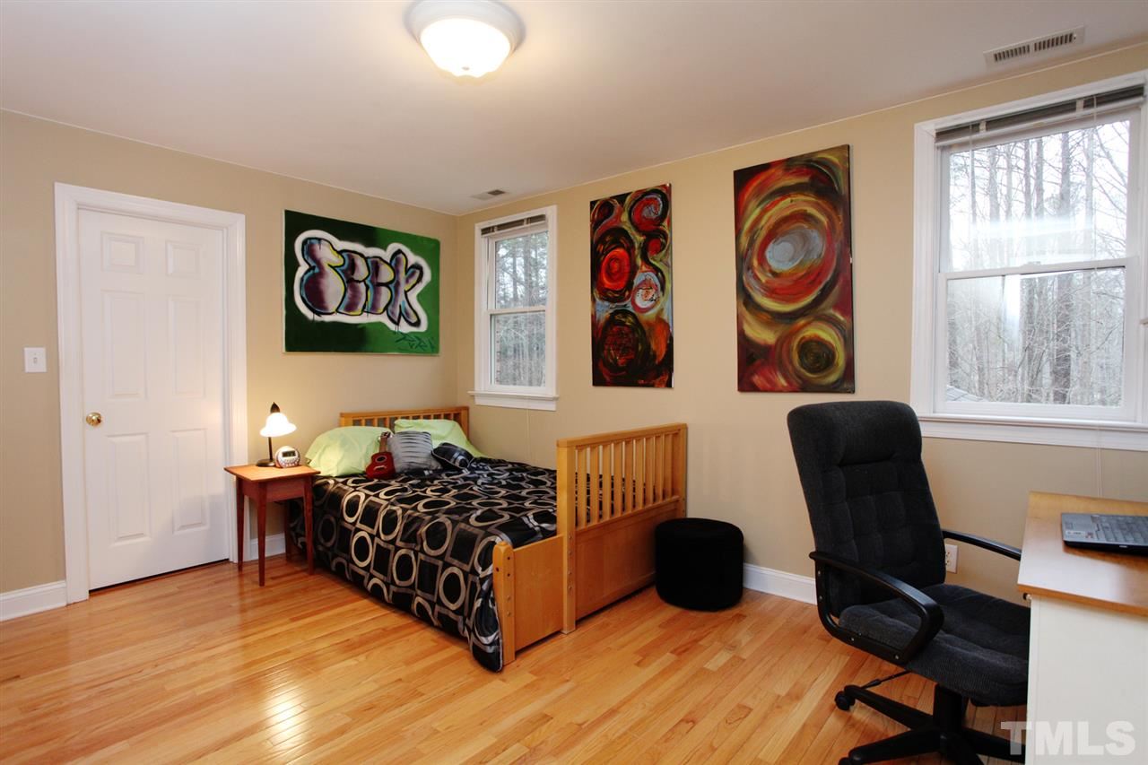 1405 Silverling Way Raleigh, NC 27613 - Photo 20 of 25 a bed room with a bed and a chair