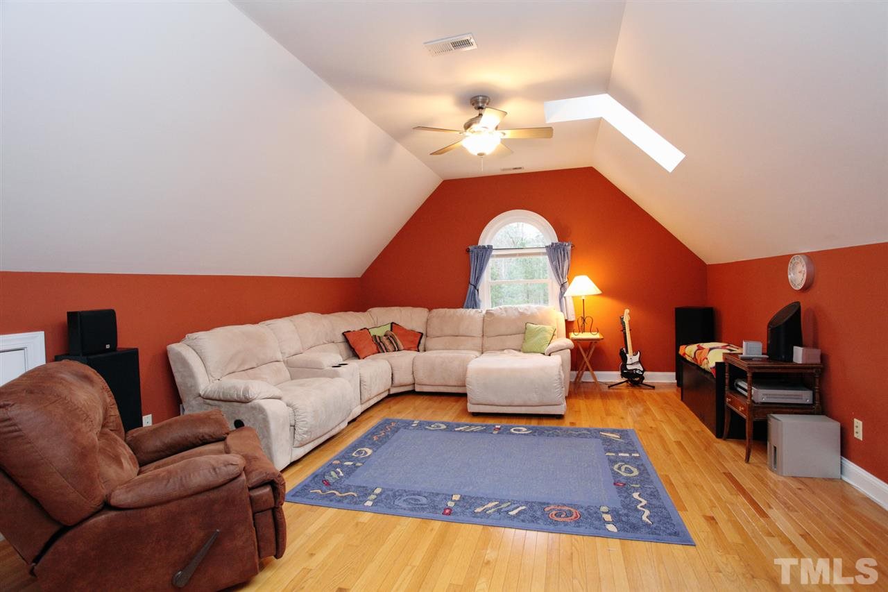 1405 Silverling Way Raleigh, NC 27613 - Photo 21 of 25 a living room with furniture and a chandelier