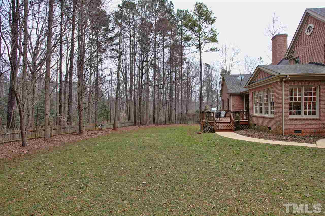 1405 Silverling Way Raleigh, NC 27613 - Photo 24 of 25 a view of a backyard with table and chairs and a fire pit