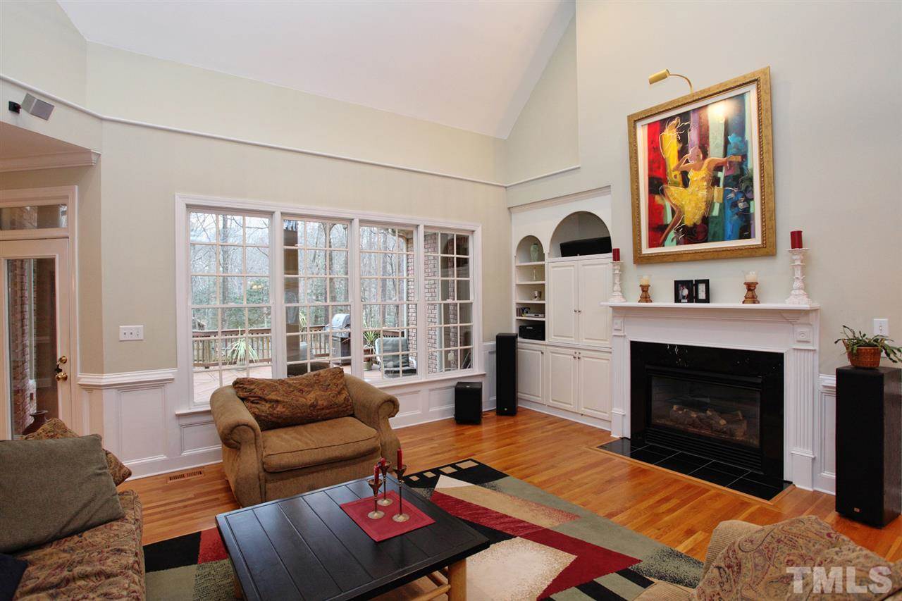 1405 Silverling Way Raleigh, NC 27613 - Photo 5 of 25 a living room with furniture a fireplace and a large window