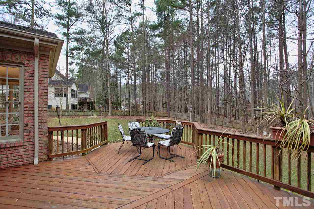 1405 Silverling Way Raleigh, NC 27613 - Photo 7 of 25 a view of a patio with table and chairs with wooden floor and fence