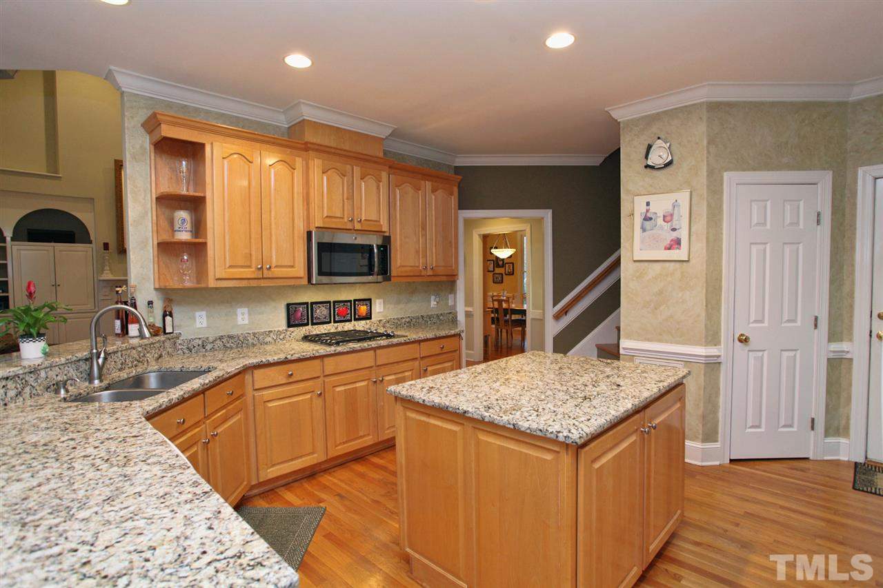 1405 Silverling Way Raleigh, NC 27613 - Photo 10 of 25 a kitchen with stainless steel appliances granite countertop a sink stove and refrigerator