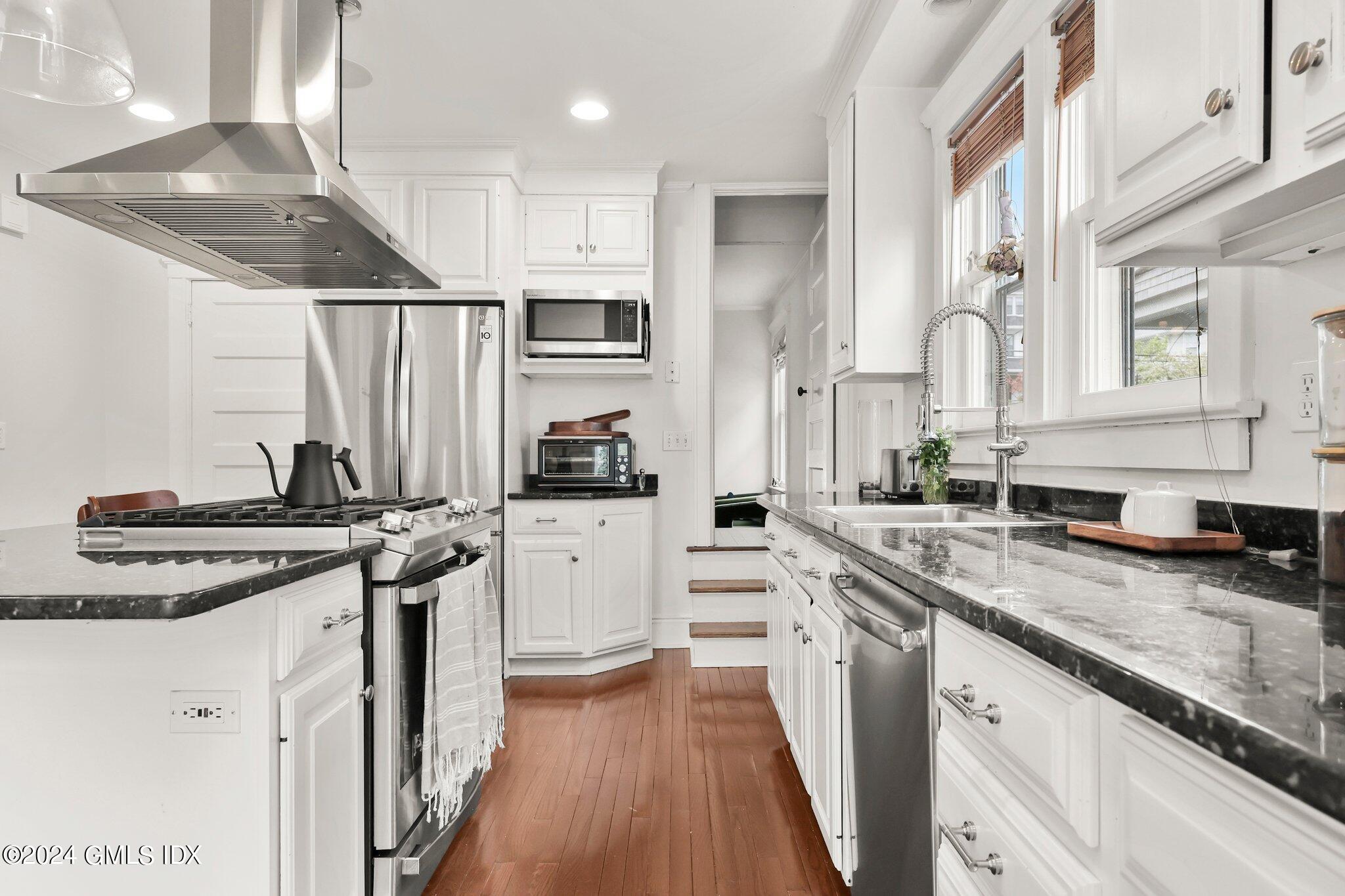 53 Ridge Street Greenwich, CT 06830 - Photo 12 of 26 a kitchen with stainless steel appliances granite countertop a stove and a sink