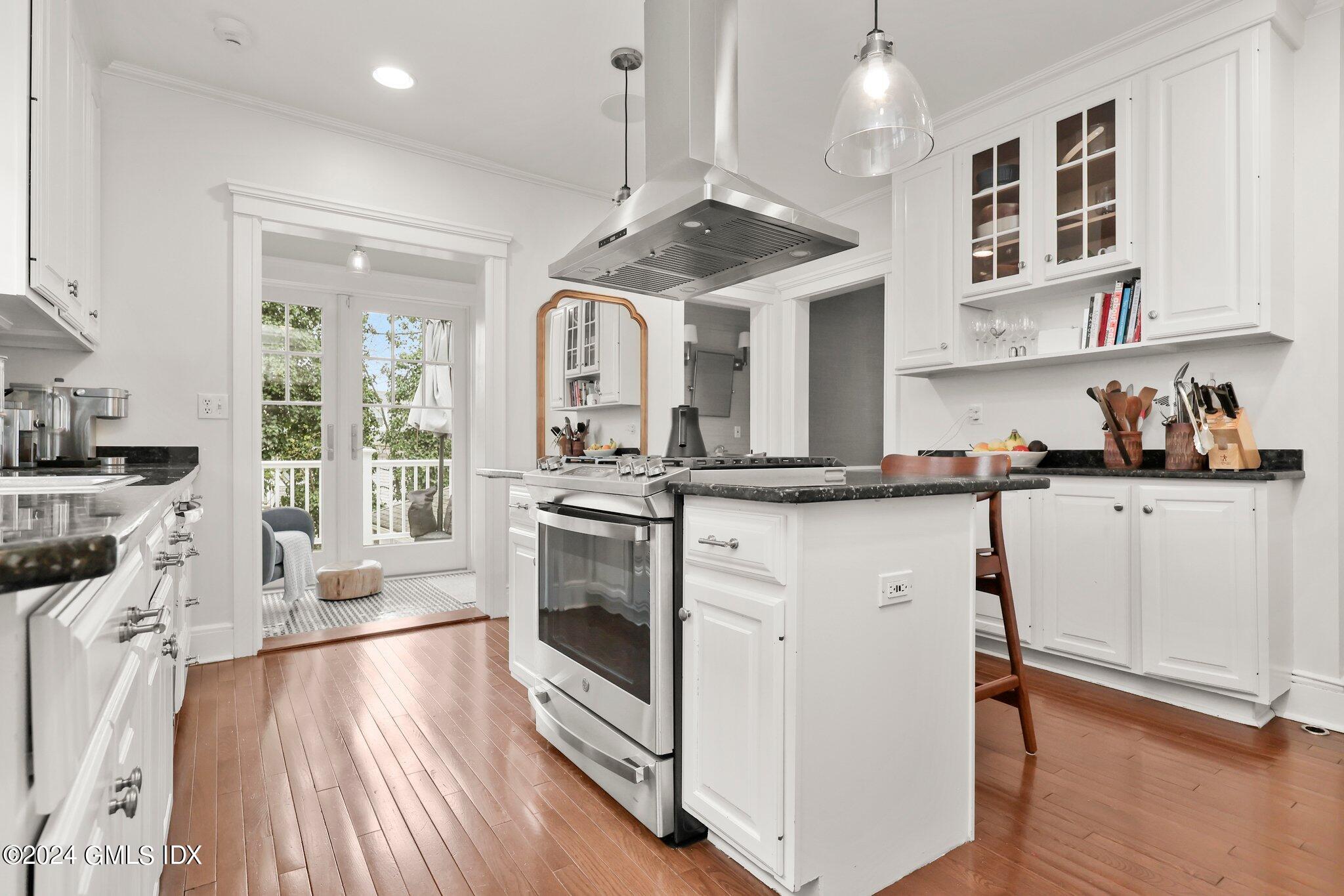 53 Ridge Street Greenwich, CT 06830 - Photo 14 of 26 a kitchen with stainless steel appliances granite countertop a stove and a wooden floors