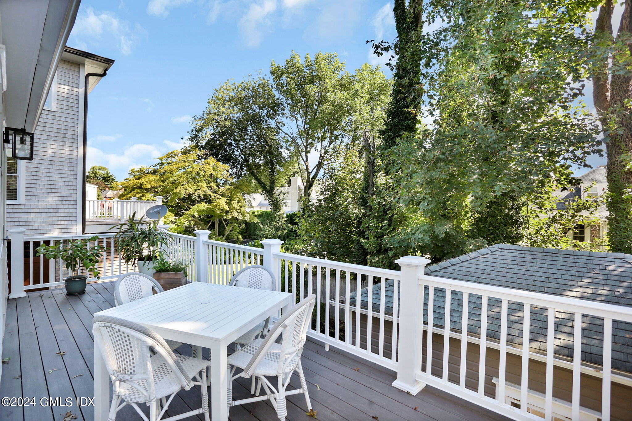 53 Ridge Street Greenwich, CT 06830 - Photo 19 of 26 a view of a patio with table and chairs with wooden floor and fence