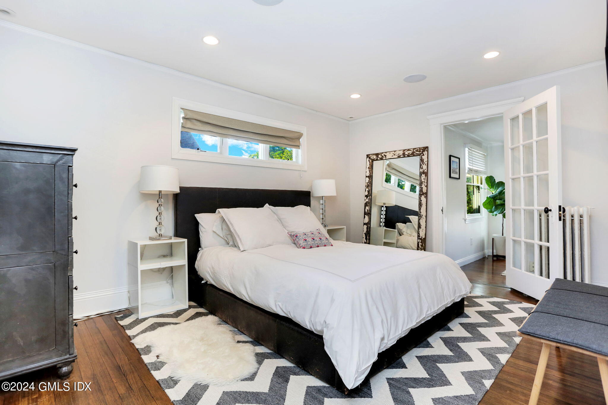 53 Ridge Street Greenwich, CT 06830 - Photo 20 of 26 a bedroom with a bed and a table