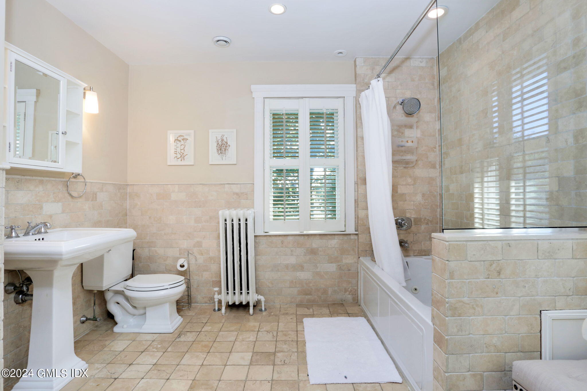 53 Ridge Street Greenwich, CT 06830 - Photo 22 of 26 a bathroom with a toilet sink and mirror
