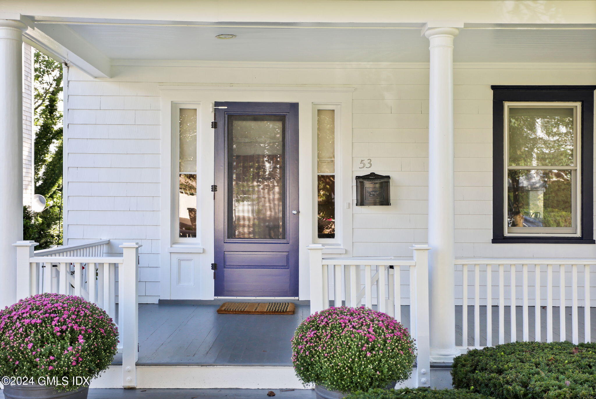 53 Ridge Street Greenwich, CT 06830 - Photo 4 of 26 a front view of a house with a garden