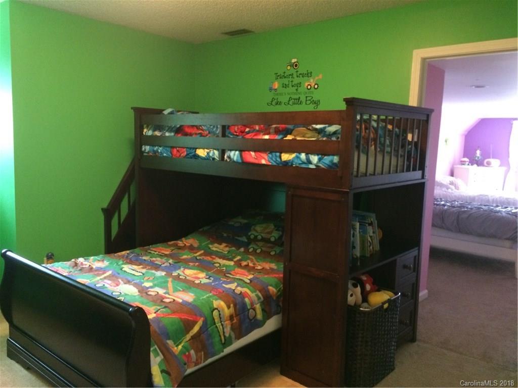 5538 Randolph Road Kannapolis, NC 28081 - Photo 12 of 36 a bed sitting in a bedroom next to a window