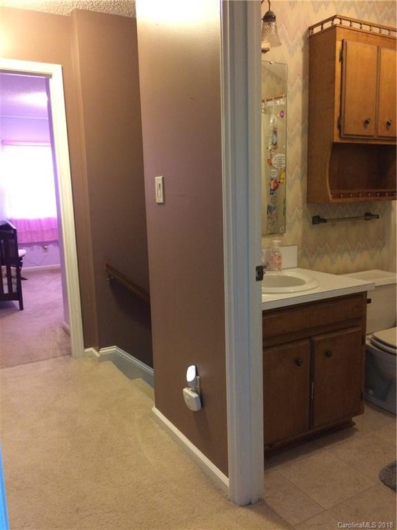 5538 Randolph Road Kannapolis, NC 28081 - Photo 16 of 36 a bathroom with a sink a mirror and a shower