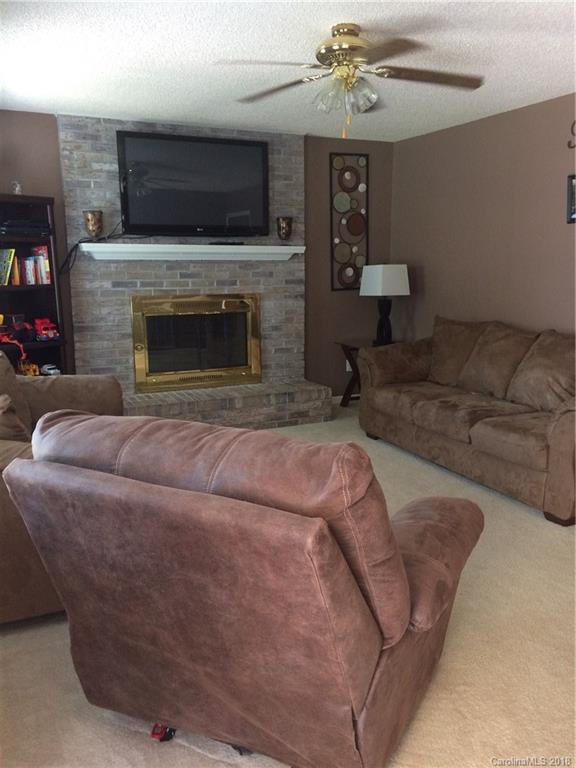 5538 Randolph Road Kannapolis, NC 28081 - Photo 18 of 36 a living room with furniture a flat screen tv and a fireplace