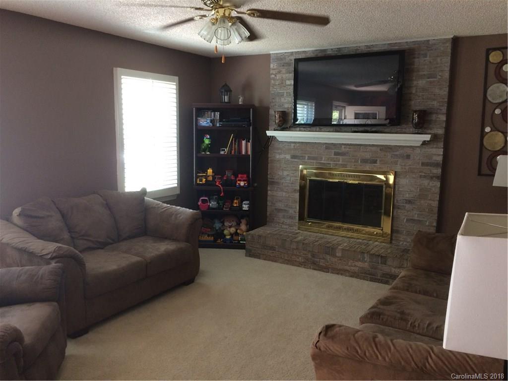 5538 Randolph Road Kannapolis, NC 28081 - Photo 19 of 36 a living room with furniture a flat screen tv and a fireplace