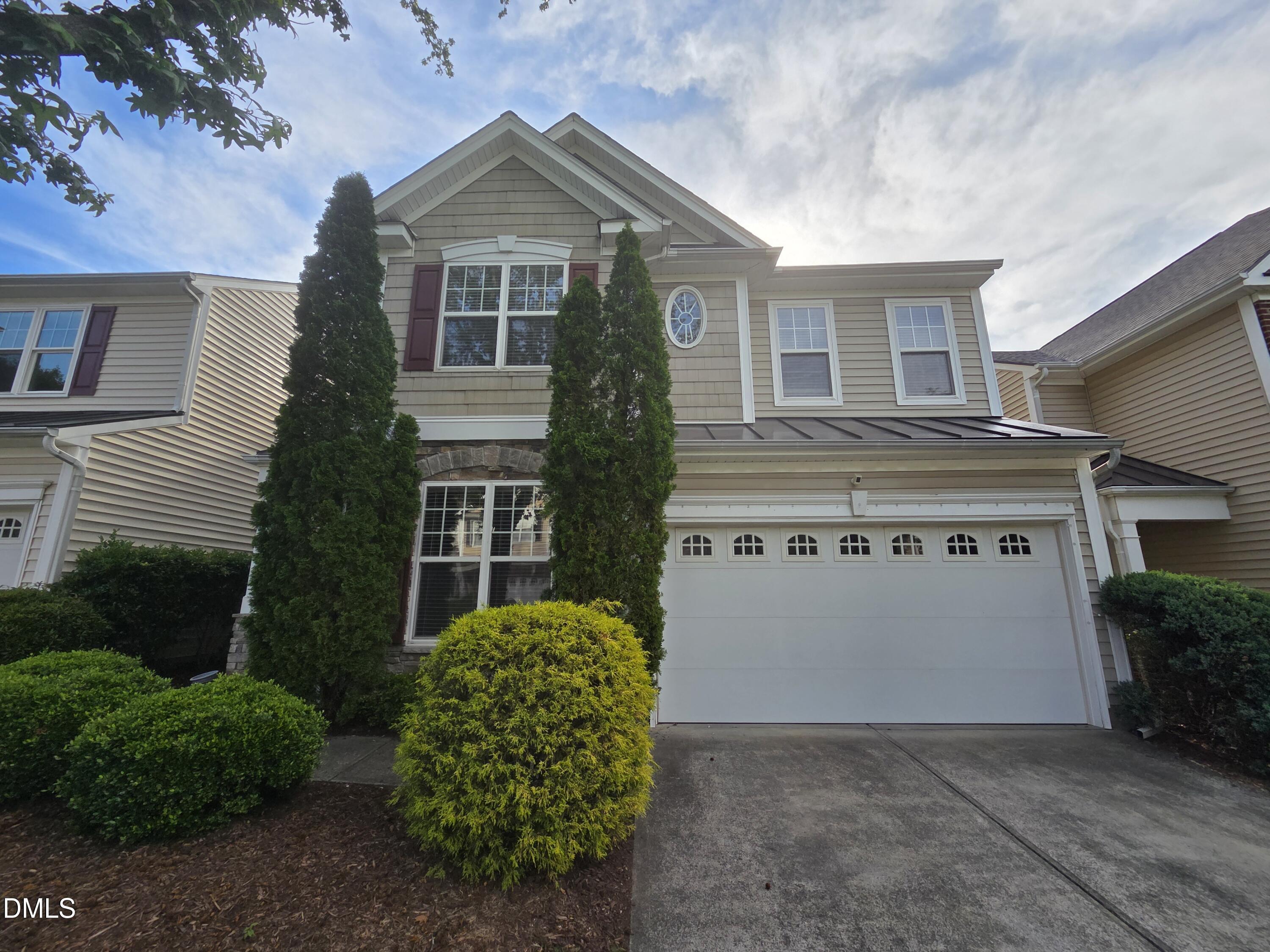 8208 Stone Cellar Drive Raleigh, NC 27613 - Photo 1 of 25 a front view of a house with a garden