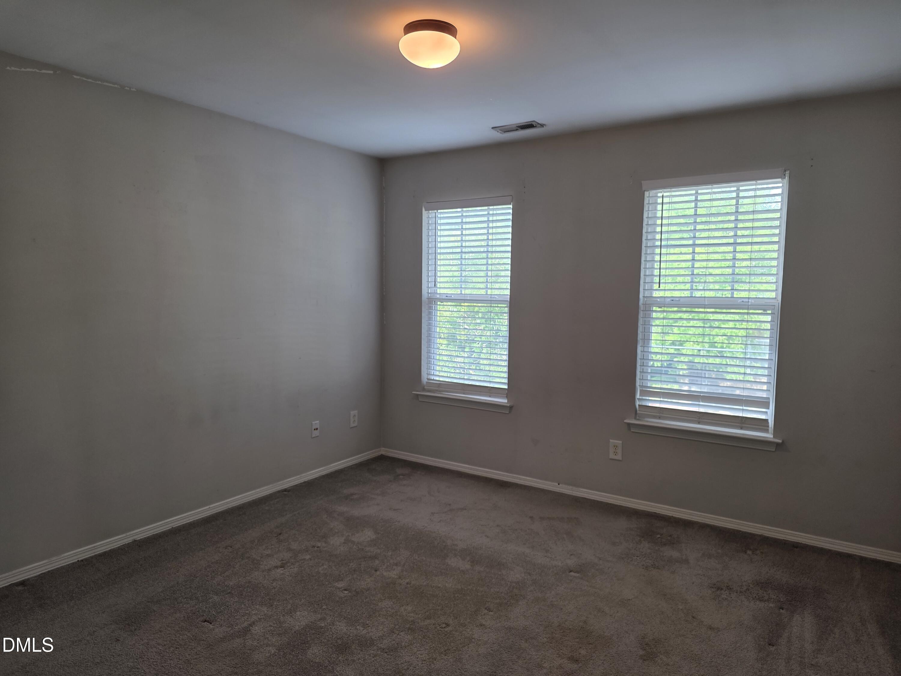 8208 Stone Cellar Drive Raleigh, NC 27613 - Photo 11 of 25 an empty room with a window