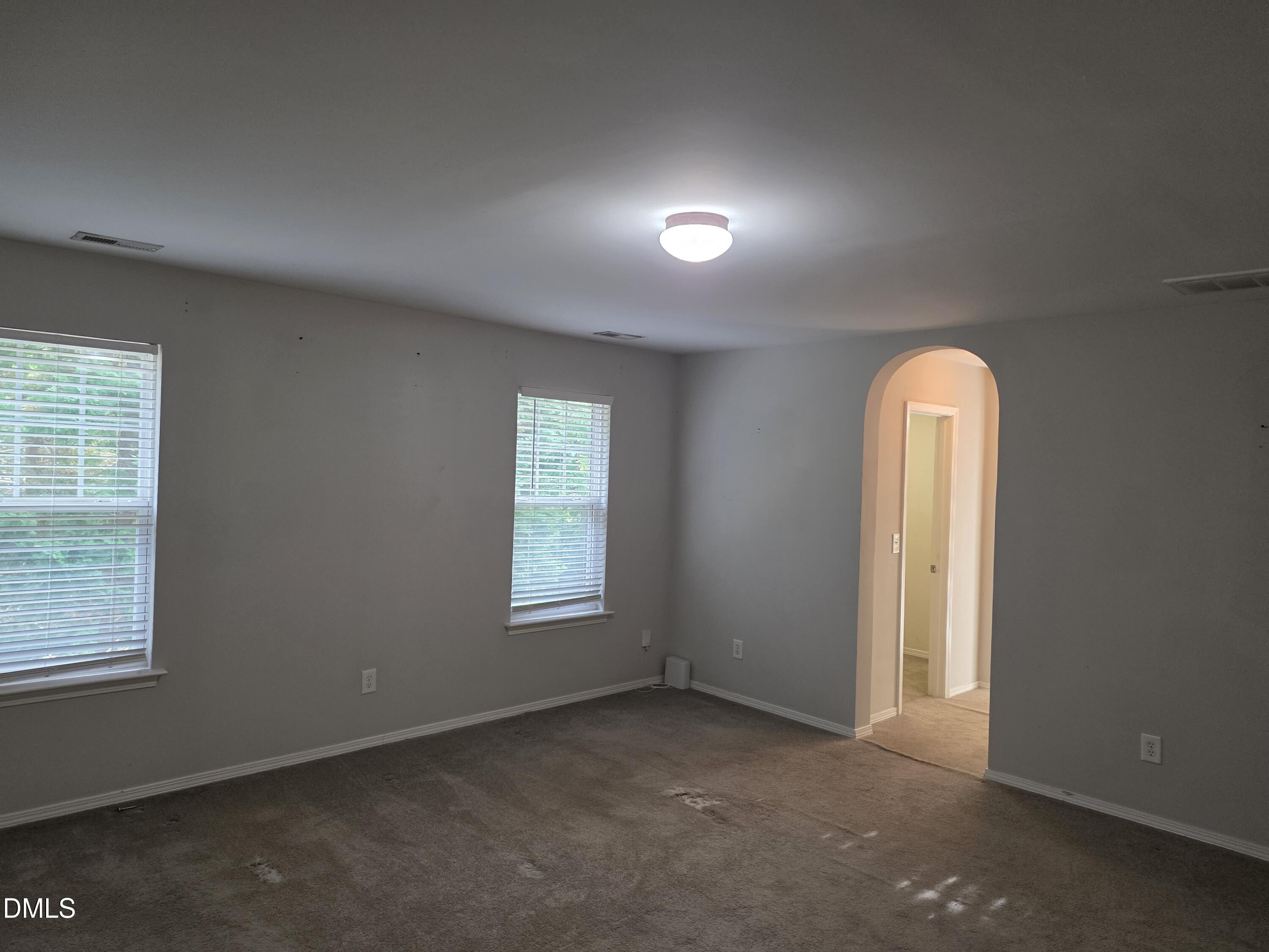 8208 Stone Cellar Drive Raleigh, NC 27613 - Photo 13 of 25 an empty room with windows and closet