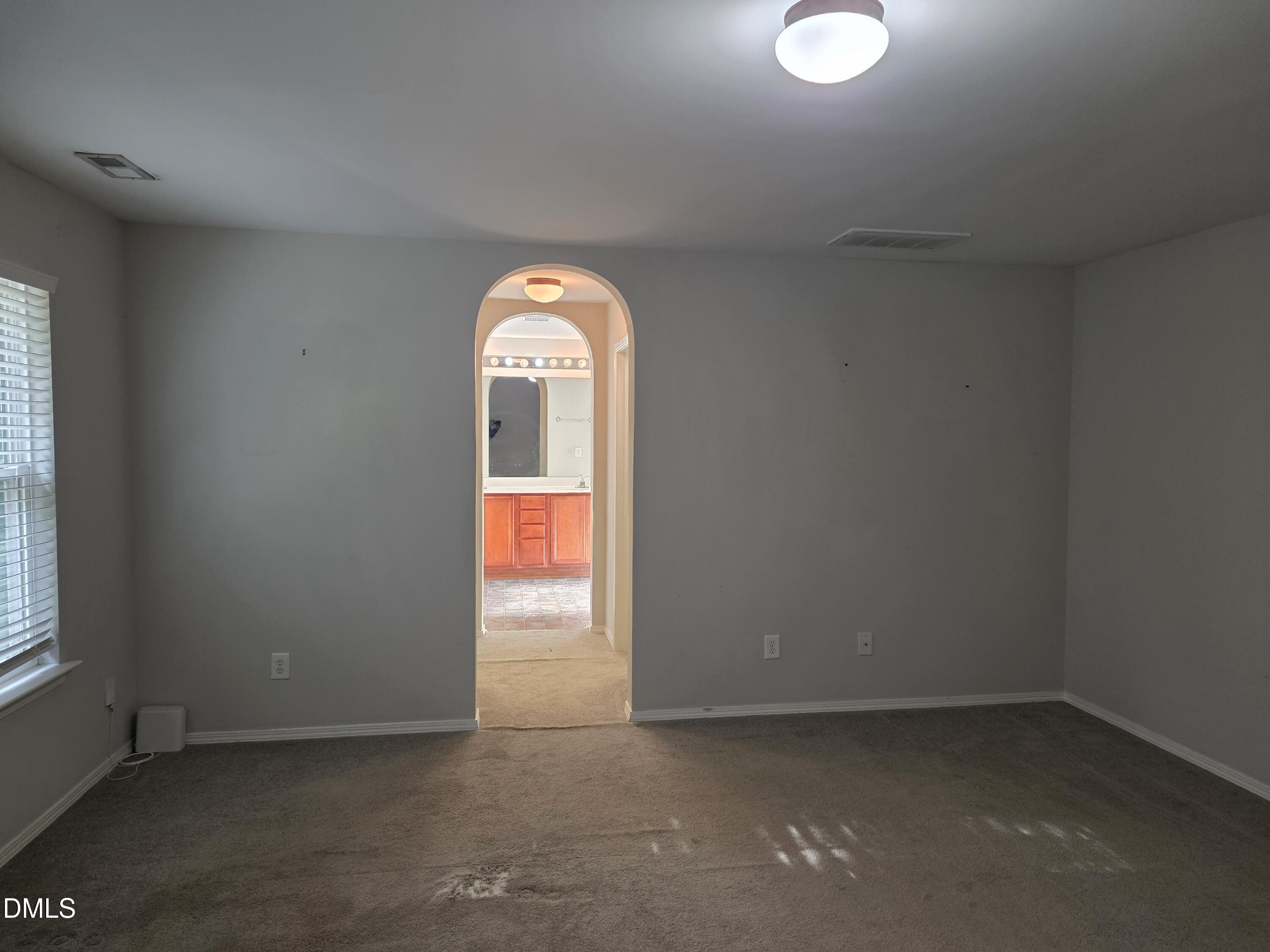 8208 Stone Cellar Drive Raleigh, NC 27613 - Photo 14 of 25 an empty room with windows