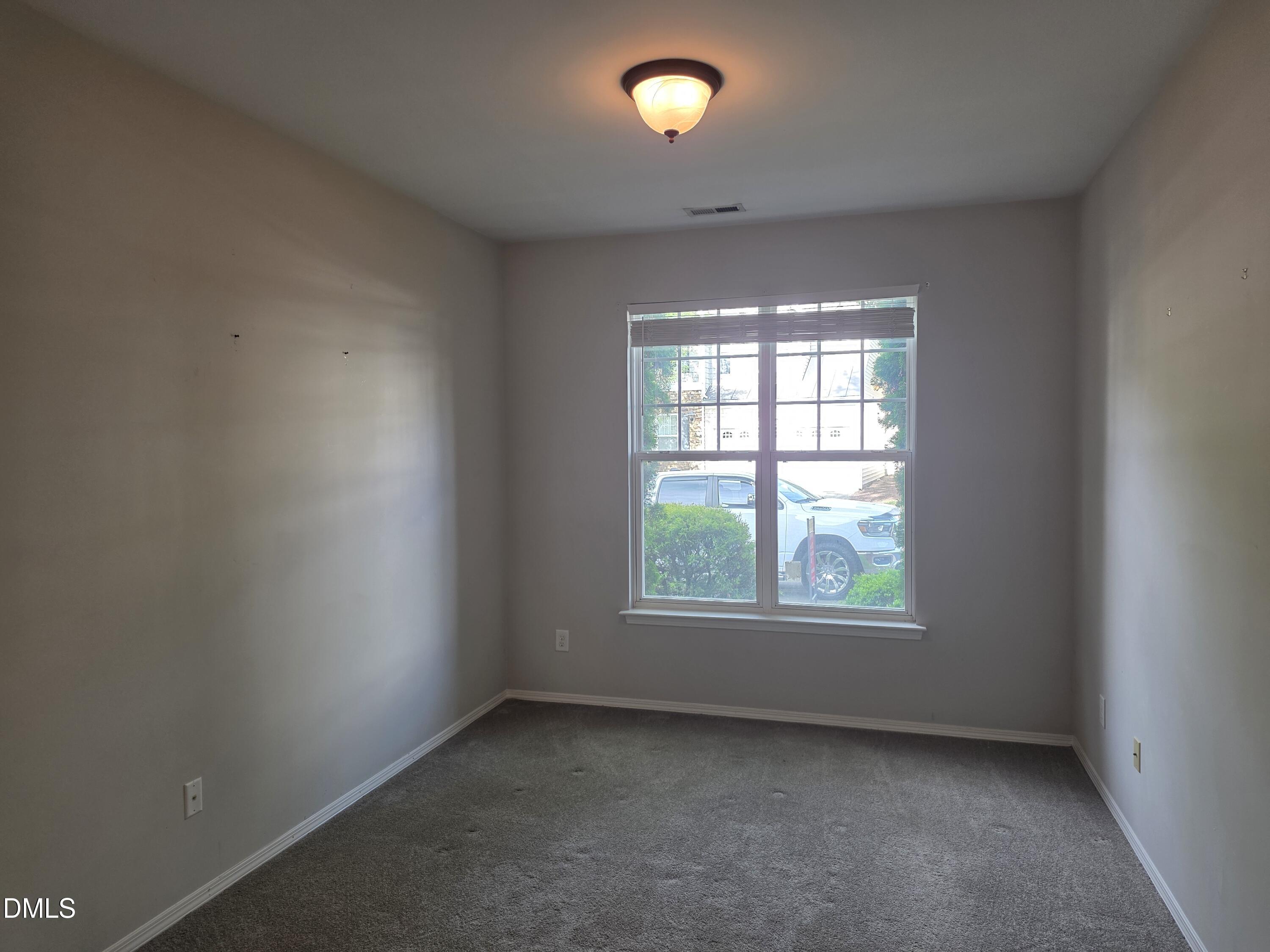 8208 Stone Cellar Drive Raleigh, NC 27613 - Photo 17 of 25 an empty room with a window