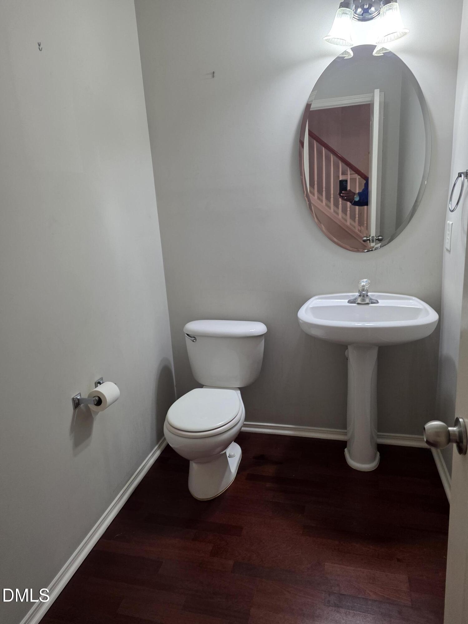 8208 Stone Cellar Drive Raleigh, NC 27613 - Photo 18 of 25 a bathroom with a toilet sink and mirror