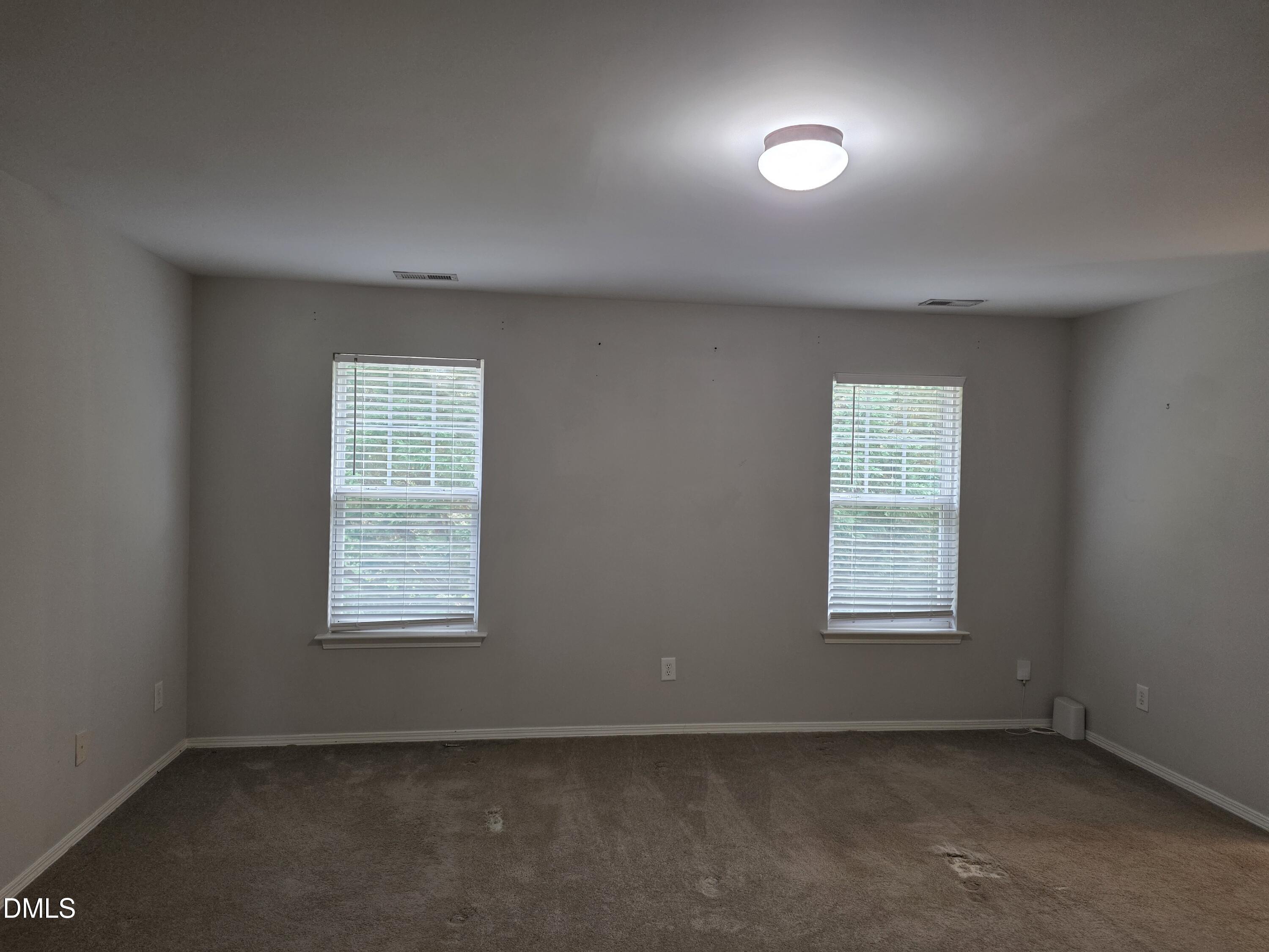 8208 Stone Cellar Drive Raleigh, NC 27613 - Photo 4 of 25 an empty room with a window
