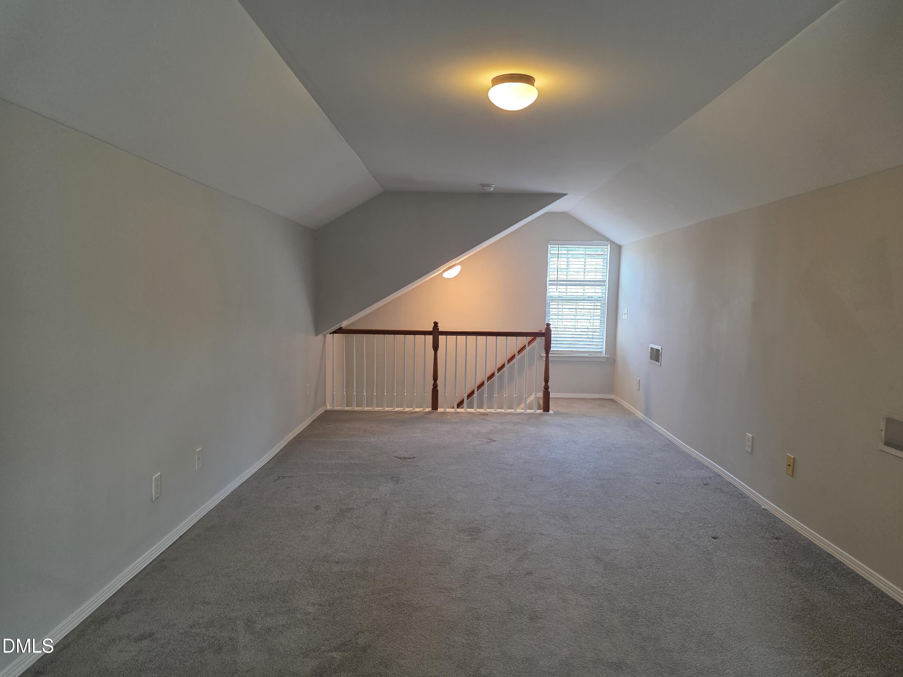 8208 Stone Cellar Drive Raleigh, NC 27613 - Photo 7 of 25 an empty room with a empty space and windows