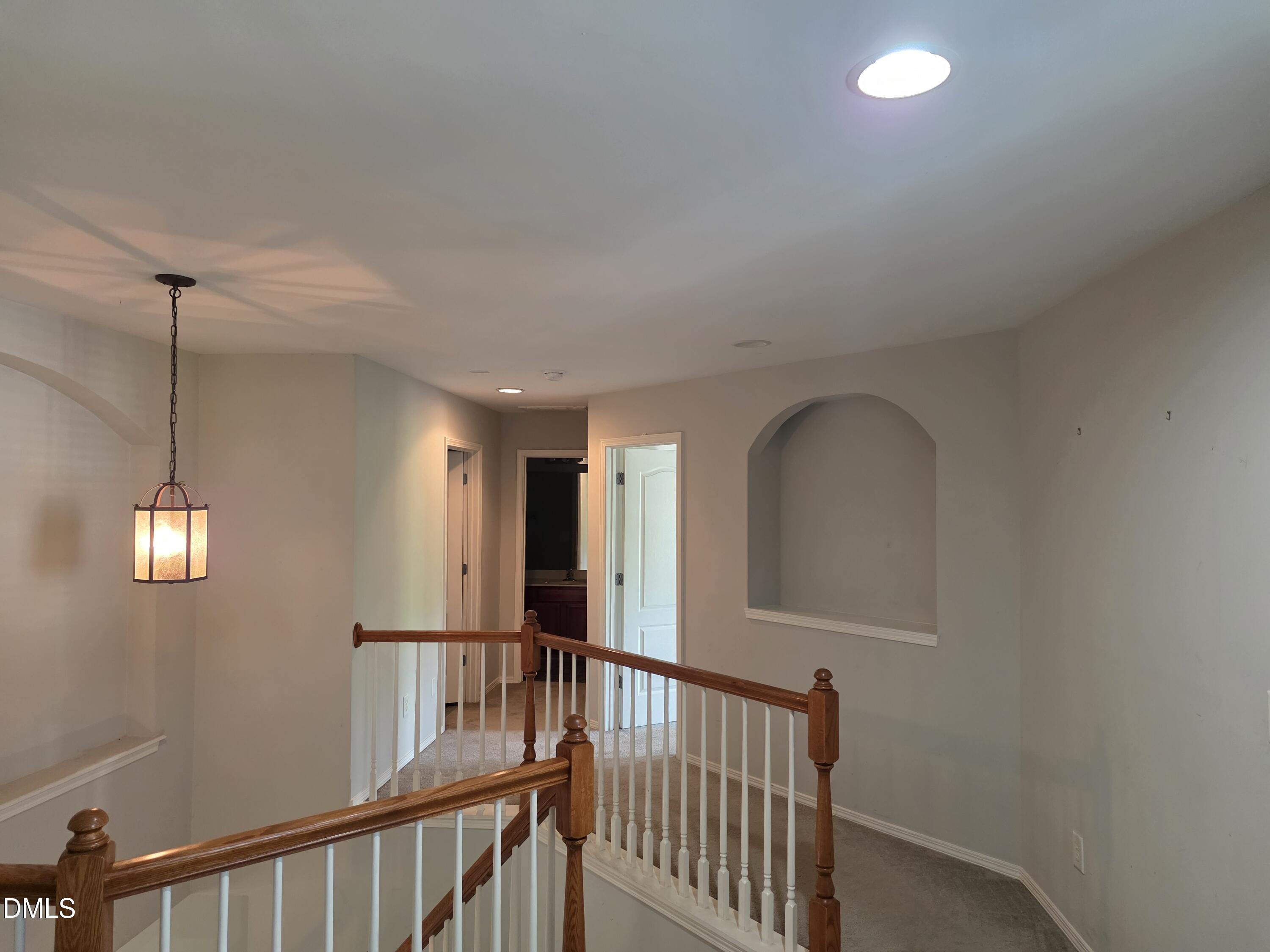 8208 Stone Cellar Drive Raleigh, NC 27613 - Photo 8 of 25 a view of a hallway with windows