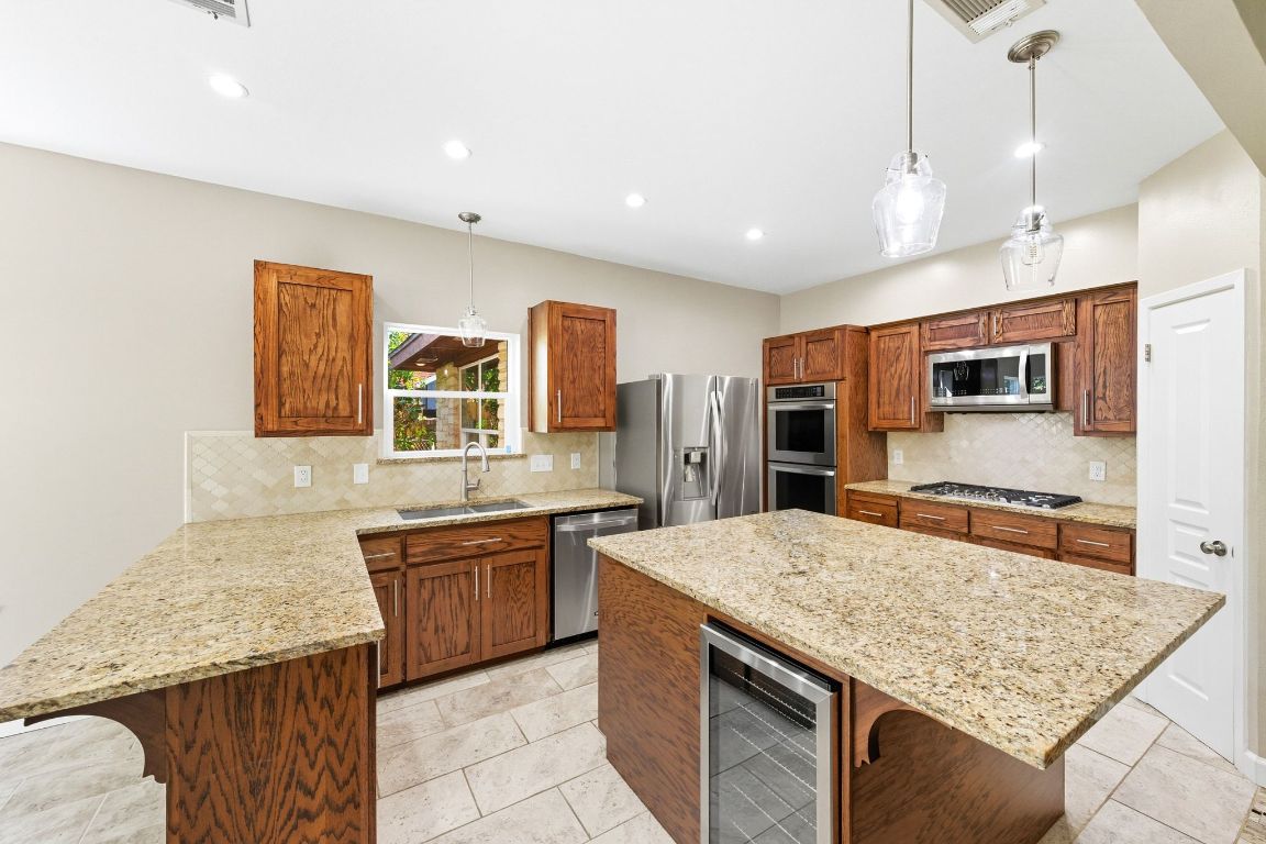 1904 Cedar Ridge Drive Austin, TX 78741 - Photo 13 of 40 a kitchen with stainless steel appliances granite countertop granite counter tops and a stove
