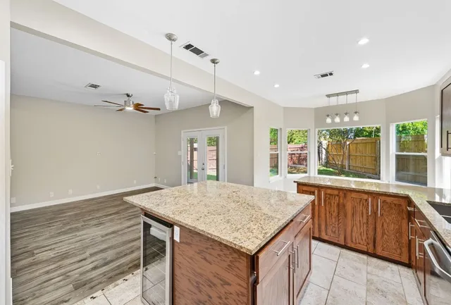 a kitchen with a sink and wooden cabinets