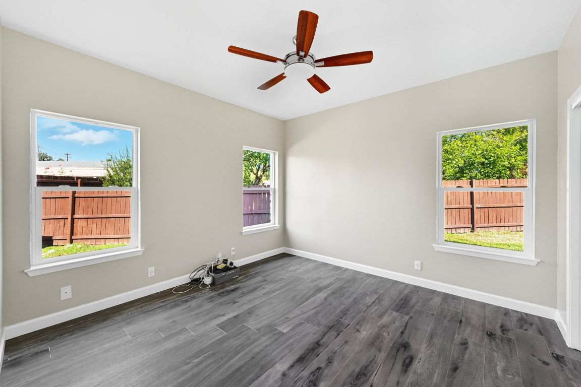 1904 Cedar Ridge Drive Austin, TX 78741 - Photo 20 of 40 a view of an empty room with a window and wooden floor