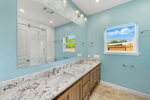 a bathroom with a granite countertop sink a mirror and a