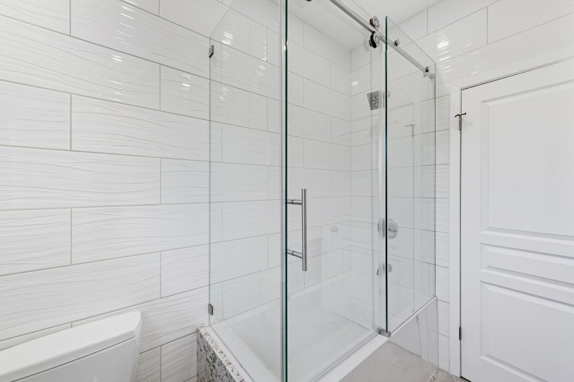 1904 Cedar Ridge Drive Austin, TX 78741 - Photo 23 of 40 a bathroom with a shower and a glass door