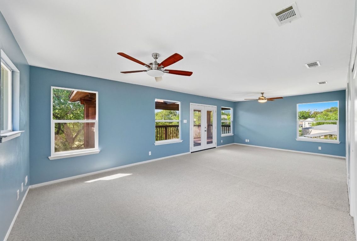 1904 Cedar Ridge Drive Austin, TX 78741 - Photo 24 of 40 an empty room with windows and fan