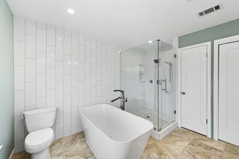 a white toilet sitting next to a bathroom sink