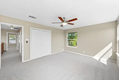 a view of a big room with closet area and windows