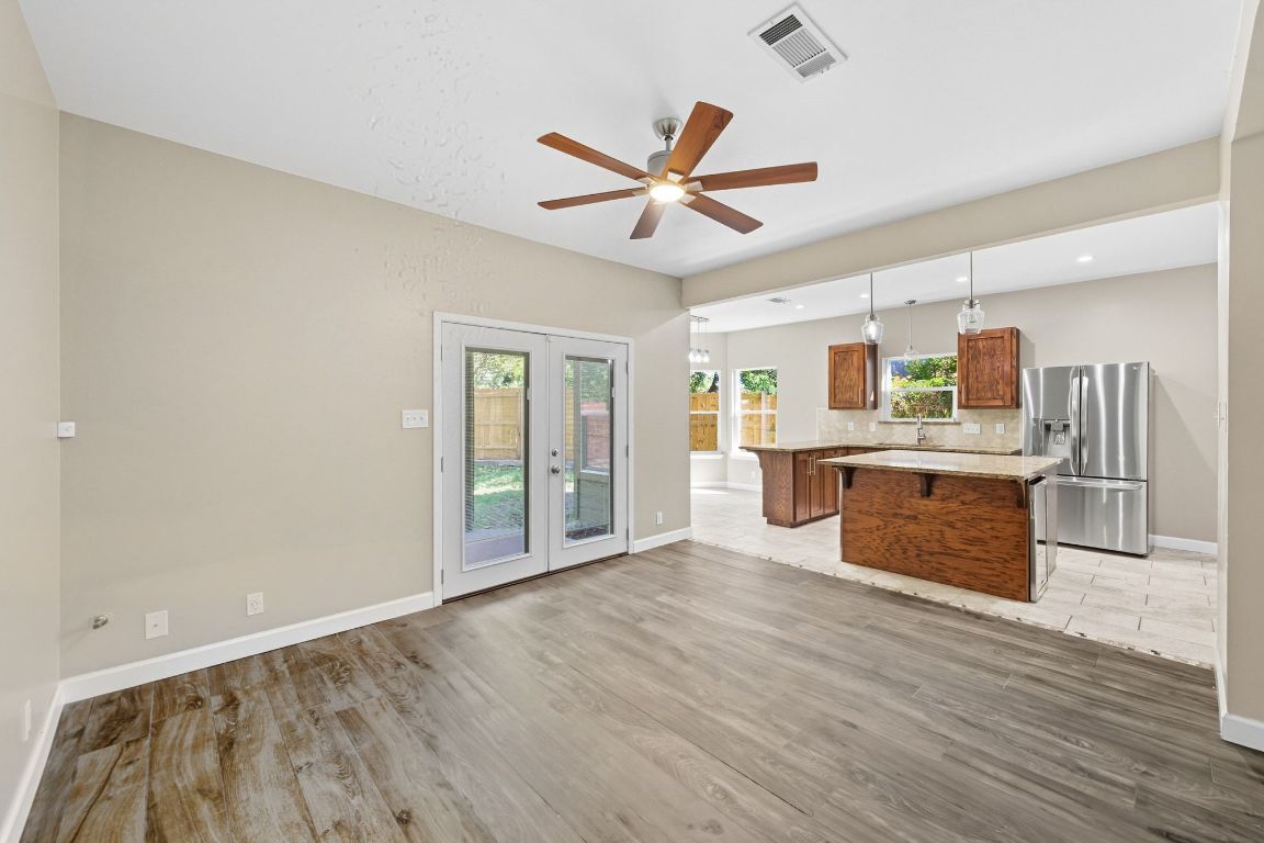 1904 Cedar Ridge Drive Austin, TX 78741 - Photo 10 of 40 a view of kitchen with stainless steel appliances granite countertop a stove top oven a sink and a refrigerator with wooden floors