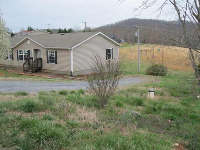 1064 Parrish Road Goodview, VA 24095 - Photo 19 of 21 a view of a yard in front of a house with large tree