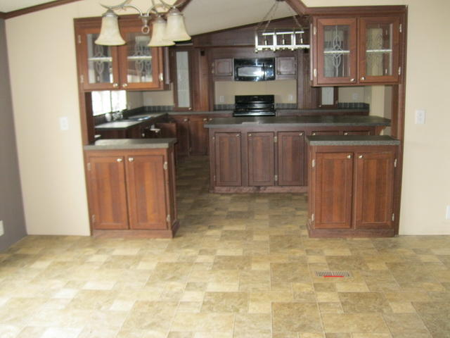 1064 Parrish Road Goodview, VA 24095 - Photo 6 of 21 a kitchen with stainless steel appliances granite countertop a stove and cabinets