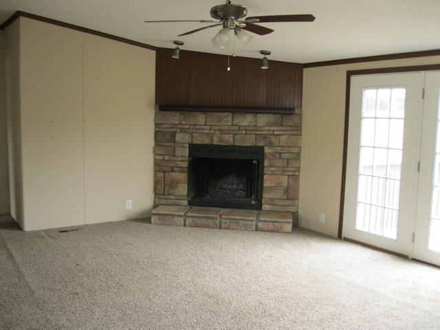 1064 Parrish Road Goodview, VA 24095 - Photo 8 of 21 an empty room with windows and fireplace