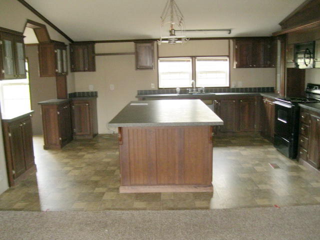 1064 Parrish Road Goodview, VA 24095 - Photo 9 of 21 a kitchen with a sink a counter top space and cabinets