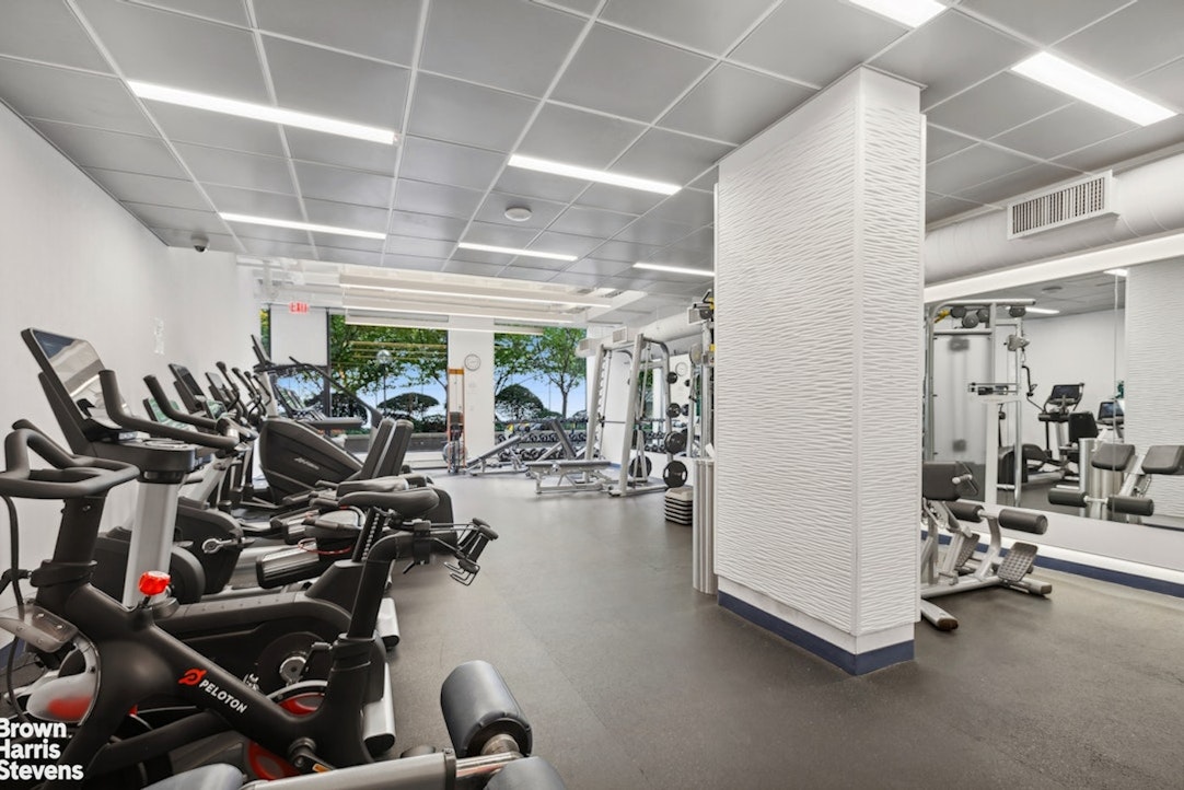 425 East 58th Street, Unit 16A Manhattan, NY 10022 - Photo 11 of 12 a view of a room with gym equipment