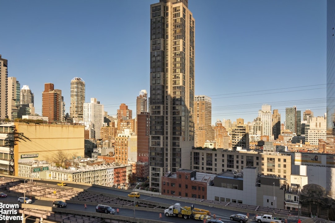 425 East 58th Street, Unit 16A Manhattan, NY 10022 - Photo 7 of 12 a city view with tall buildings