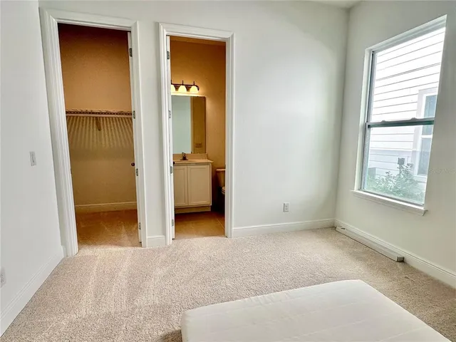 an empty room with windows and closet