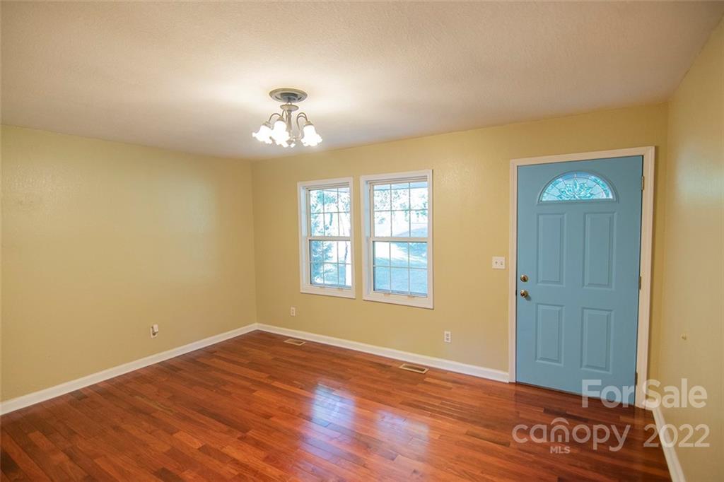 284 Berkeley Road Hendersonville, NC 28792 - Photo 3 of 23 wooden floor in an empty room with a window