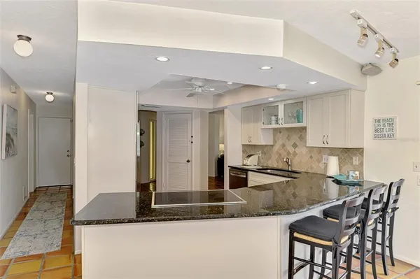 a kitchen with a stove a sink and a refrigerator