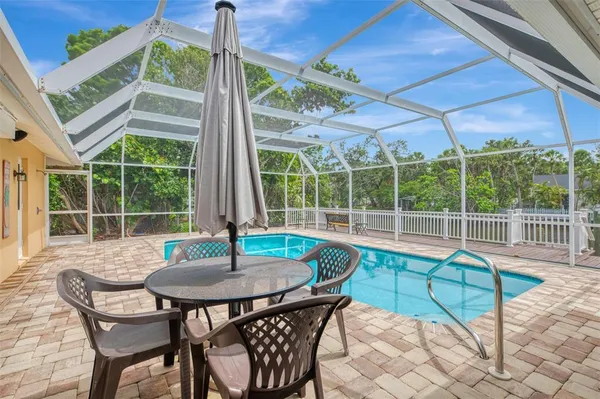 a view of a roof deck with table and chairs and wooden floor